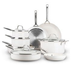 an assortment of white pots and pans on a white background with one pot in the middle