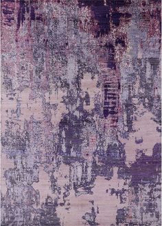 an area rug with various colors and patterns on it, including pinks, purples, and greys