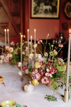 a table with candles and flowers on it