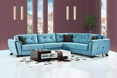 a living room with a blue sectional couch and coffee table in front of purple walls