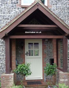 a white door sitting in front of a brick building