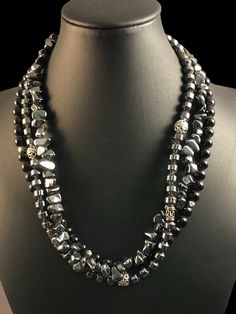 "A great looking black triple strand necklace. Each strand is different and one compliments the next. The first strand is round Black Onyx beads with small silver tone beads. The second strand is made of Hematite barrel shaped beads interspersed with silver beads. The final strand is made of Hematite chips. The closure is a unique Sterling Silver toggle. The necklace is 16\" long." Hematite Necklace, Onyx Bead, Strand Necklace, Black Onyx, Silver Beads, Necklace Etsy, Onyx, Barrel, Silver Tone