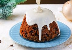 a blue plate topped with a bundt cake covered in icing