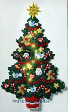 a christmas tree made out of felt with lights on it and teddy bears hanging from the top