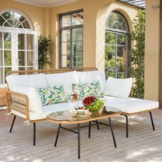 a white couch sitting on top of a wooden table