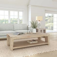 a living room with a couch, coffee table and two lamps on the side tables