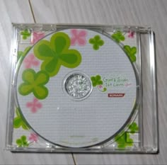 the cd is in its plastic case with flowers on it's front and side