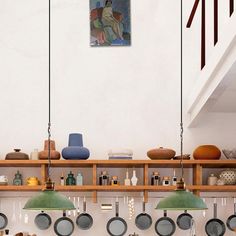 a kitchen with pots and pans hanging from the ceiling