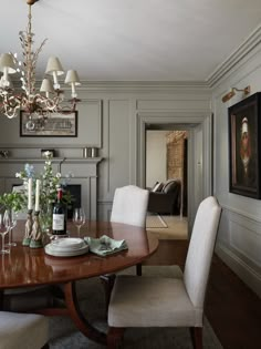 the dining room table is set with wine glasses and plates