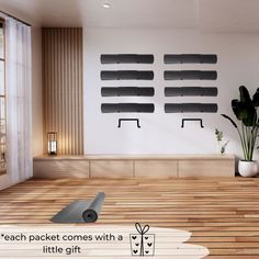 a room with wooden flooring and black wall art on the walls, along with a yoga mat