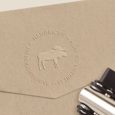 a close up of a stamp on a piece of paper with a horse logo in the middle