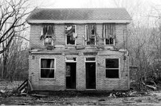 an old run down house with broken windows