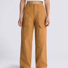 The Arroyo Wide Leg Cargo Pants is a classic workwear inspired piece with a modern style in an all-new hue. These canvas pants offer lots room, lots of style, and lots of storage with its wide-legged style and plethora of pockets. 100% Cotton fabric Relaxed fit canvas wide leg cargo pant Front and back patch pockets Side cargo pockets 12.5'' rise 28'' inseam 15.5'' leg opening | Vans Arroyo Wide Leg Cargo Pants Womens 30 Inch Cotton Full-length Cargo Pants For Work, Fall Workwear Full-length Cargo Pants, Full-length Cotton Cargo Jeans For Work, Full Length Cotton Cargo Jeans For Work, High-waisted Cotton Cargo Work Pants, High-waisted Wide Leg Pants With Multiple Pockets For Work, Brown Parachute Pants With Side Pockets For Work, High Waist Utility Cotton Work Pants, Full-length Cargo Work Pants