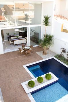 an aerial view of a house with a pool and dining area in the back ground