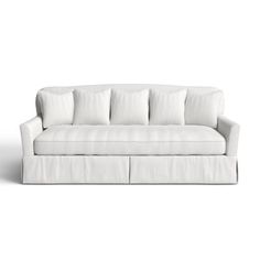 a white couch with four pillows on it