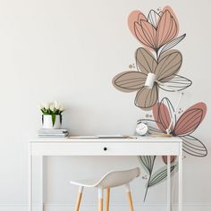 a white desk with a flower wall decal on it