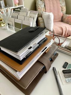 a stack of notebooks sitting on top of a table