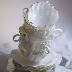 a stack of white cups sitting on top of each other