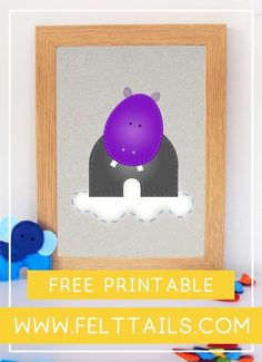 a purple ball sitting on top of a table next to a wooden frame with the word free printable