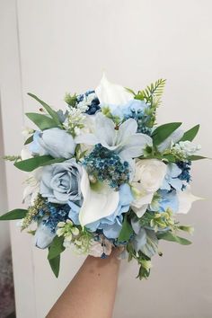 a bridal bouquet with blue and white flowers