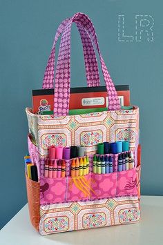 a bag that has some crayons in it and is sitting on a table