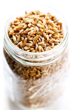 a glass jar filled with seeds on top of a table