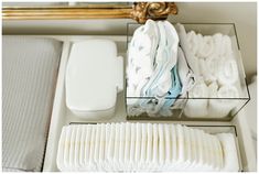 the tray is filled with folded towels and other items to use as a diaper dispenser