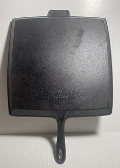 a black spatula sitting on top of a white table