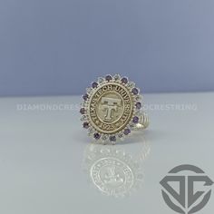 an image of a gold ring with purple stones