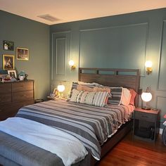 a bedroom with blue walls and wooden floors