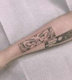 a person with a tattoo on their arm has a knife in front of his face