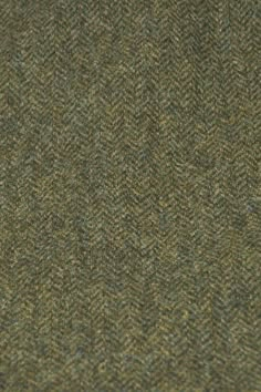 a close up view of a green and brown tweed fabric