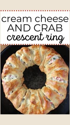 a cranberry and cream cheese crescent ring on a black plate with text overlay