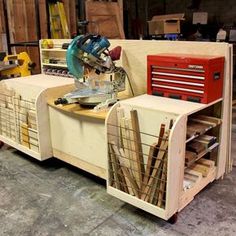 a work bench made out of wood with tools on it in a garage area next to other items