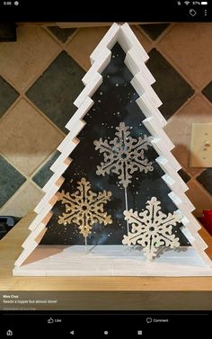 a paper snowflake christmas tree on a table