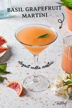 a glass filled with a drink sitting on top of a table next to sliced fruit