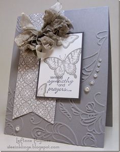 a close up of a greeting card with a butterfly on the front and an embellishment in the back