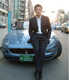 a man sitting on the hood of a car