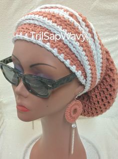 a mannequin wearing sunglasses and a crocheted hat