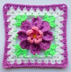 a crocheted square with a flower on it