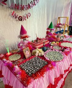 a table covered in pink and red decorations