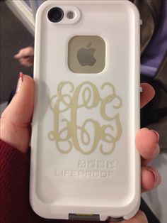 a person holding an iphone case with the initials on it