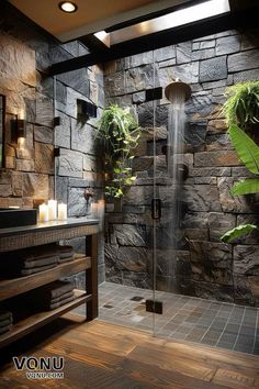 a very nice looking bathroom with some plants on the wall and a shower in it