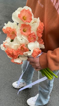 a person holding a bouquet of flowers in their hands