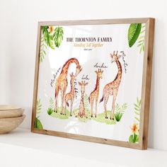 a wooden frame with two giraffes and flowers on the wall behind it