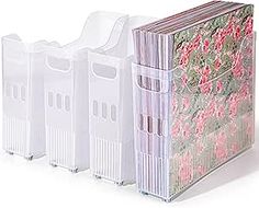 four plastic storage bins are lined up against each other on a white background with pink flowers