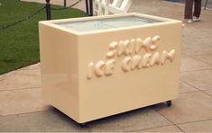 an ice cream cooler sitting on top of a sidewalk