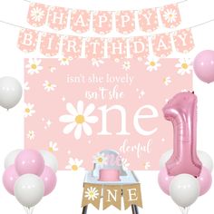 a pink first birthday party with balloons and decorations