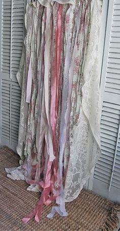 an old dress hanging on a door with ribbons attached to the front and back of it