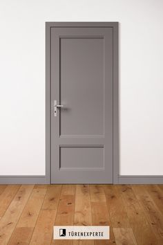 an empty room with a gray door and wooden flooring that says forexpertic